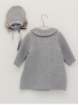Knitted coat and bonnet with pom pom
